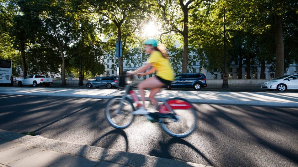 A cyclist on a Santander bike in motion on a Superhighway