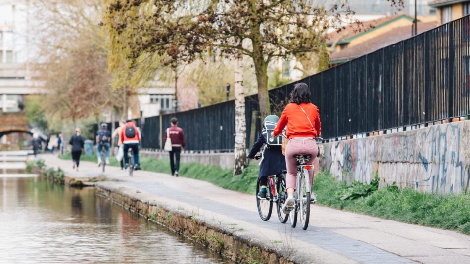Cyclists riding along the canal