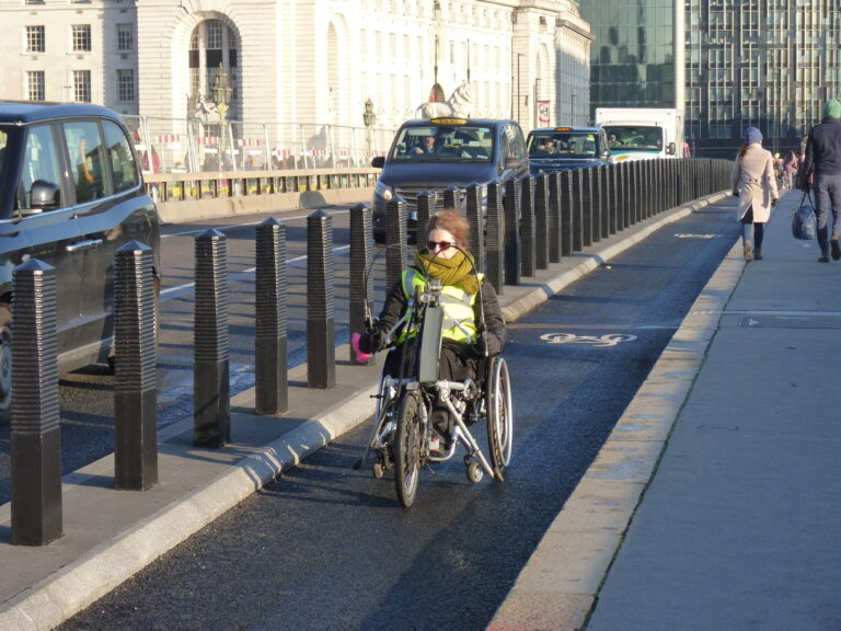 woman on hand cycle on Westminster Bridge cycle lane